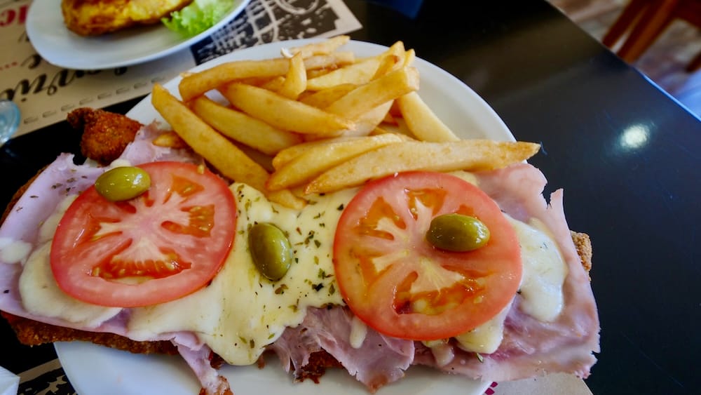 Milanesa a la Napolitana with Fries in El Calafate and Patagonia Dining Time Planning Milanesa a la napolitana with fries in El Calafate, Argentina, showing how Patagonia travel days need room for slow meals, local dining rhythms and real food stops between long transfers.