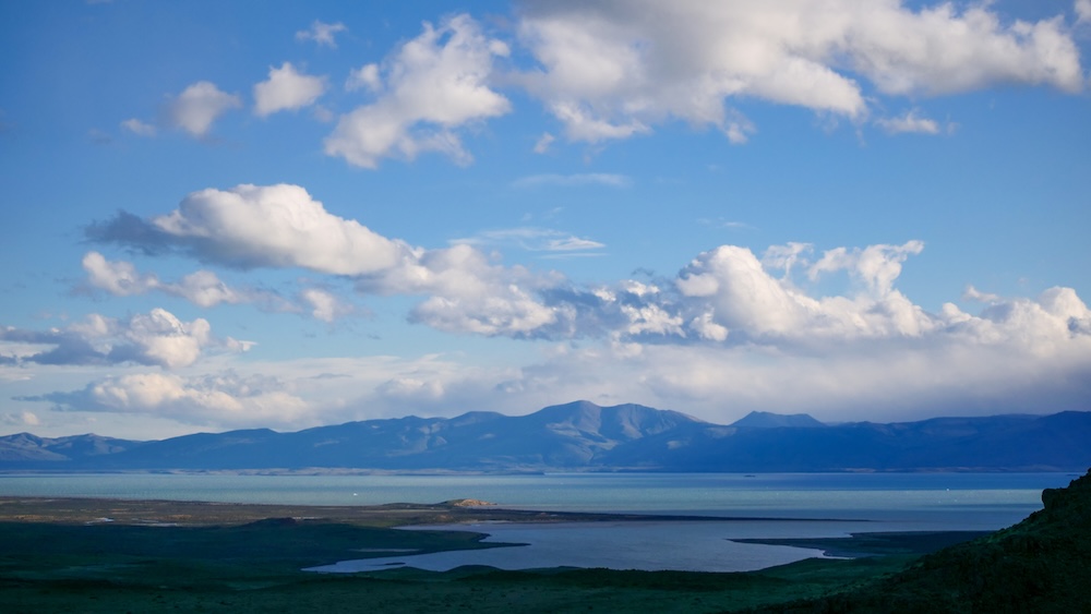 Lake Viedma panorama from Mirador de las Águilas in El Chaltén The sweeping blue waters of Lake Viedma stretch across the Patagonian steppe from the Mirador de las Águilas viewpoint in El Chaltén, delivering a vast horizon-focused payoff beyond the mountain peaks.