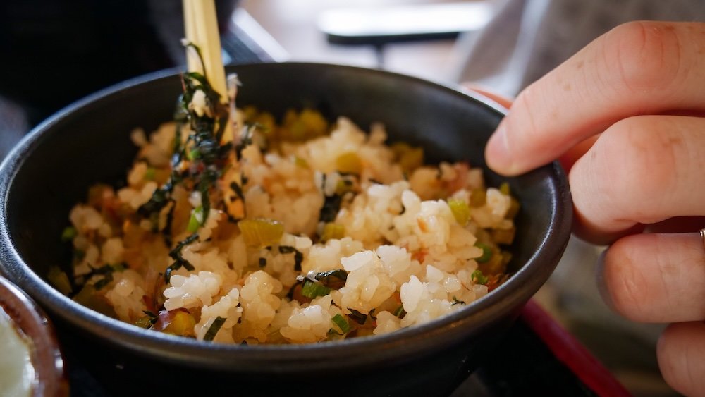 Mixed rice bowl being stirred at restaurant at Daio Wasabi Farm