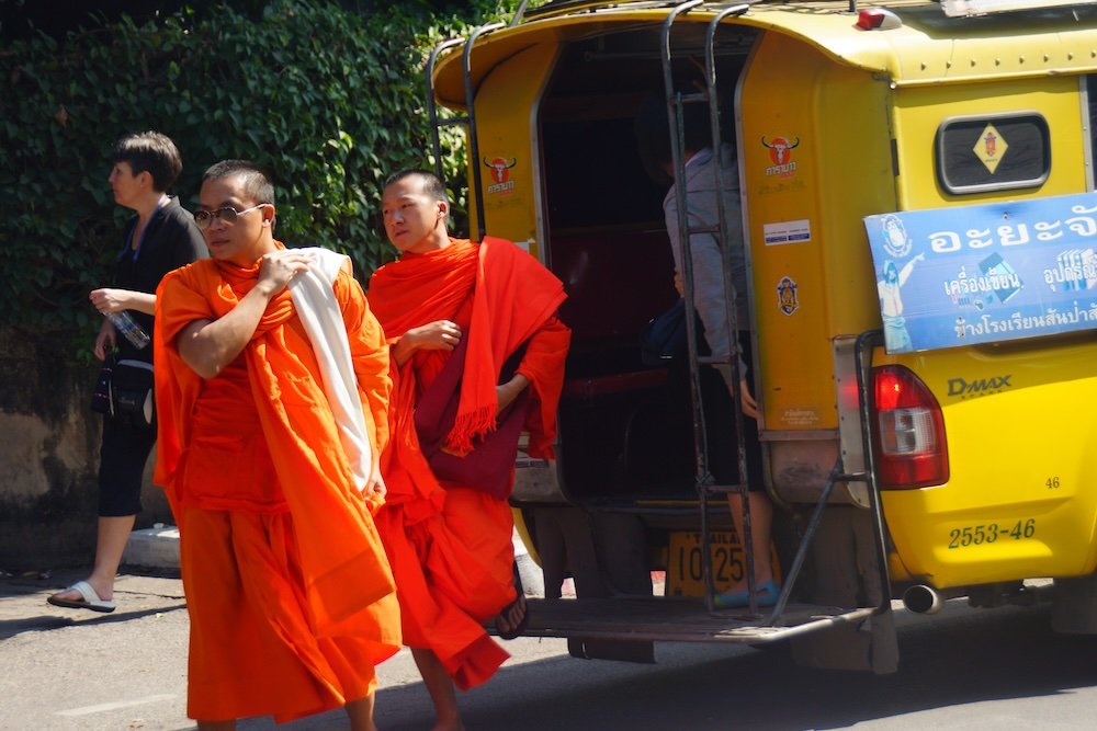 Monks getting off of Thai truck transportation option in Chiang Mai, Thailand 