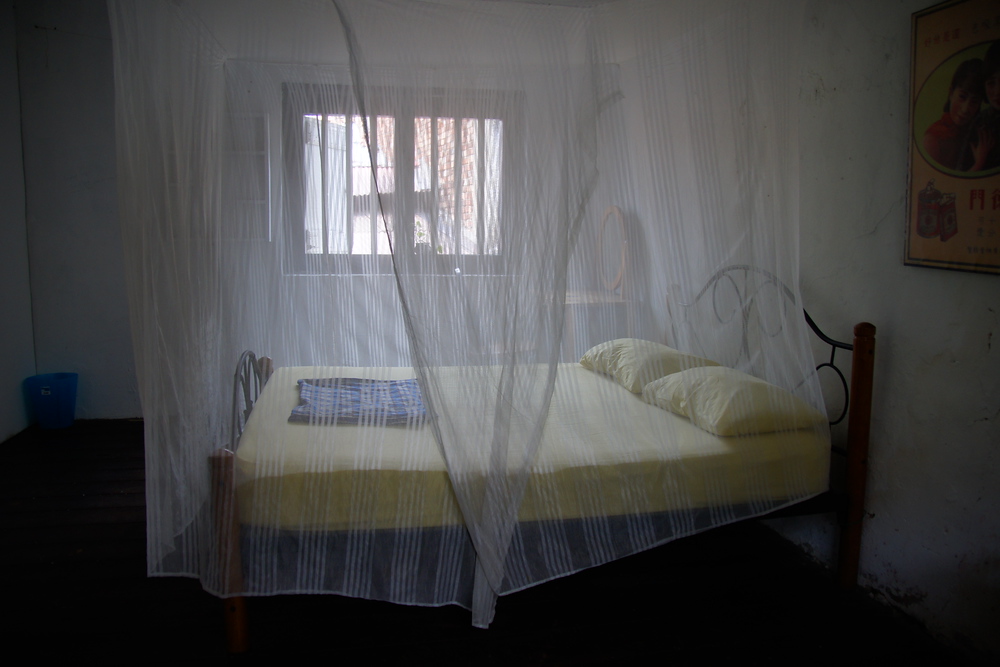 Mosquito net covering my bed at Sama Sama Guest House in Malacca, Malaysia