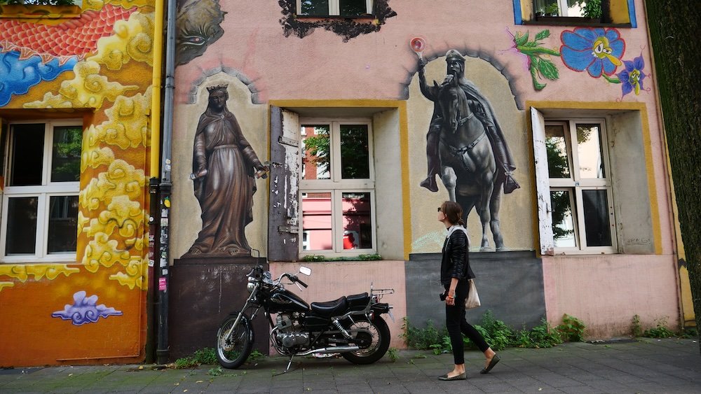 Motorcycle parked in front of graffiti in Dusseldorf, Germany 