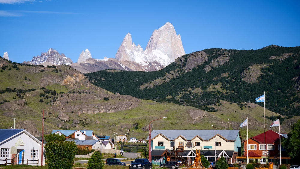 Mount Fitz Roy towering above the town of El Chaltén in Argentine Patagonia, where visitors can admire the famous granite spires directly from the streets without needing to hike deep into Los Glaciares National Park.