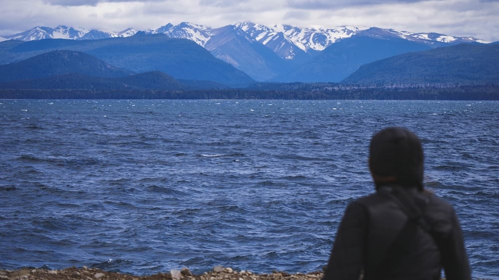 Audrey Bergner Viewing the Snowy Andes Across Nahuel Huapi Lake in Bariloche, Argentina Audrey Bergner looks across the wind-ruffled waters of Nahuel Huapi Lake toward snow-streaked Andean peaks near Bariloche, Río Negro, Patagonia, Argentina.