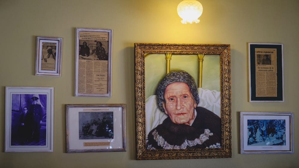 Historic photos and portrait display inside Casa de Té Nain Maggie in Trevelin Patagonia, showcasing Welsh settler heritage and family history behind the traditional tea service culture in Argentina’s Chubut region