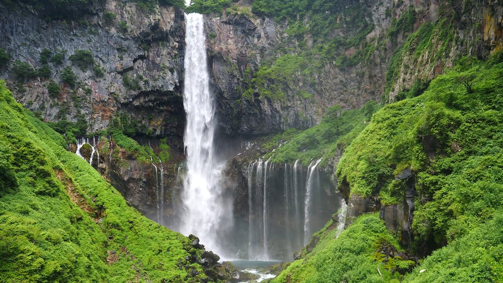 Nikko scenic waterfall in Japan amidst lush green scenery 