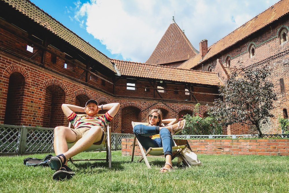 Nomadic Samuel and That Backpacker chilling at Malbork Castle in Poland on a day trip from Gdansk