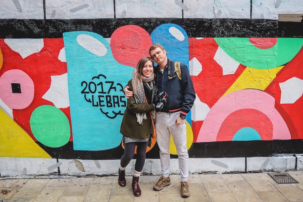 Nomadic Samuel and That Backpacker Audrey Bergner loving being in Valencia, Spain with street art in the background 