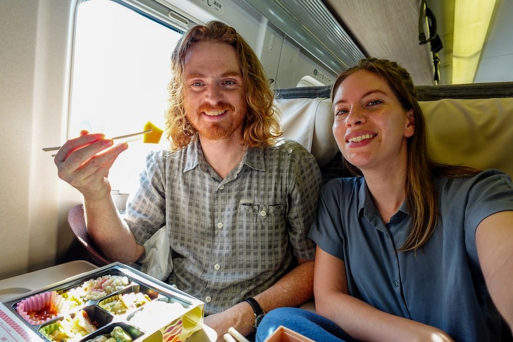 Nomadic Samuel and That Backpacker feasting on Japanese food on the train ride in Japan taking the Shinkansen 