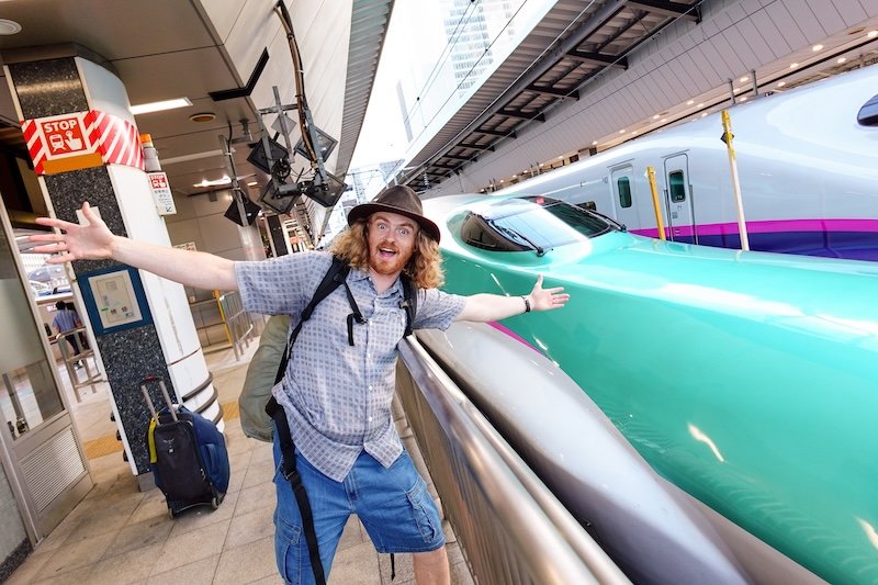 Here is Nomadic Samuel beyond thrilled to be taking the Shinkansen from Tokyo to Hokkaido on a once in a life train travel adventure in Japan