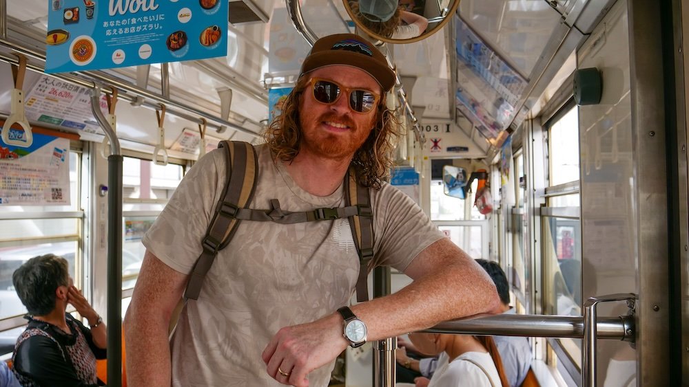 Nomadic Samuel checking his watch for the time in Hakodate, Japan. 