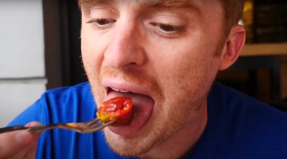 Nomadic Samuel eating currywurst in Dusseldorf, Germany 