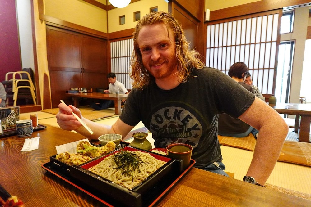 Nomadic Samuel eating Japanese noodles in Japan 