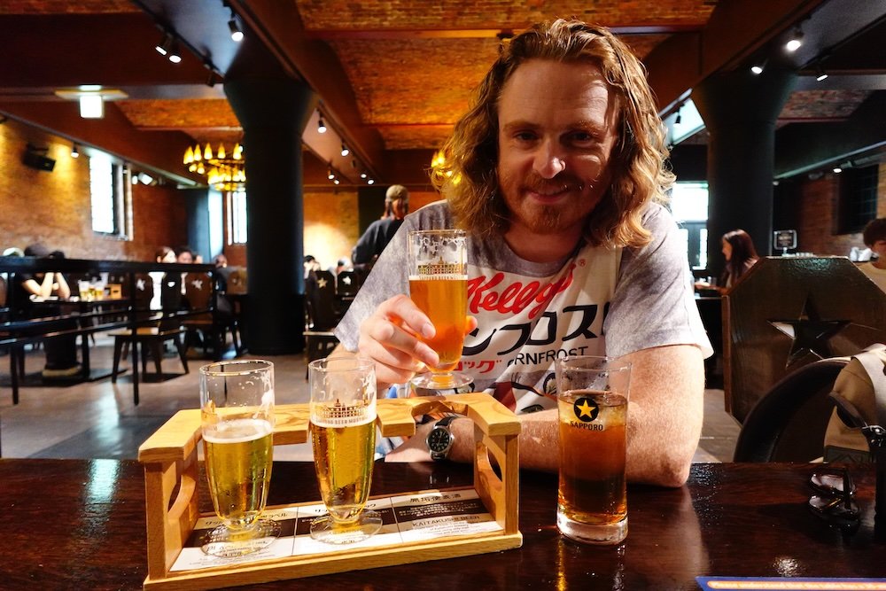 Nomadic Samuel enjoying a beer taste test in Sapporo, Japan