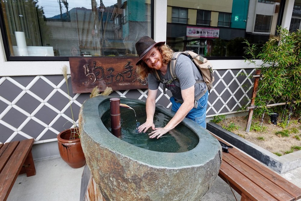 Nomadic Samuel enjoying a Hand Bath in Yuzawa