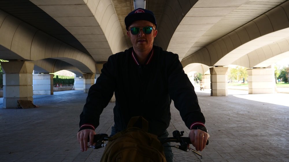 Nomadic Samuel enjoying riding a bike in Turia Park whilst visiting Valencia, Spain 