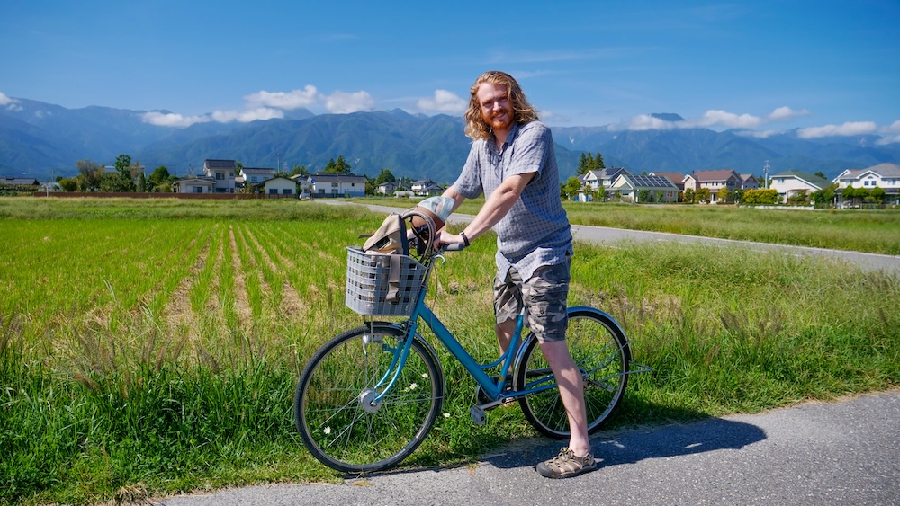 Nomadic Samuel enjoying a scenic countryside bicycle ride in Japan going from the rice fields to a Wasabi farm just outside of Matsumoto.
