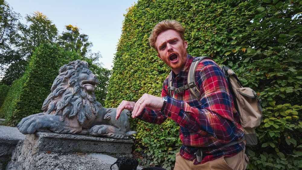 Nomadic Samuel enjoying the lion statue in Salzburg, Austria 