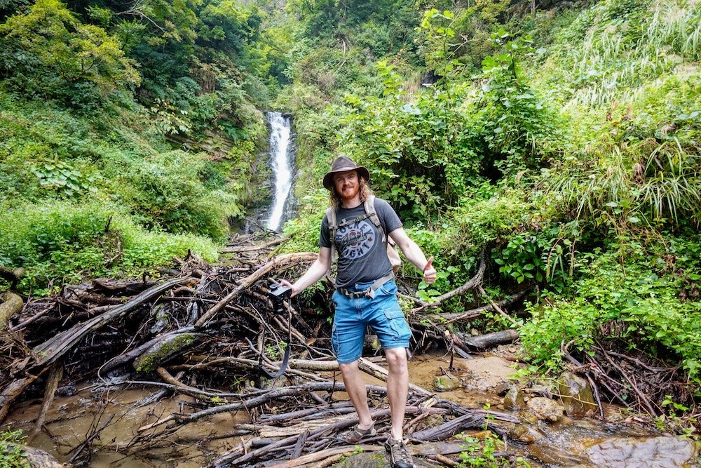 Nomadic Samuel enjoying waterfalls along with scenic views in Yuzawa in Niigata prefecture in Japan 