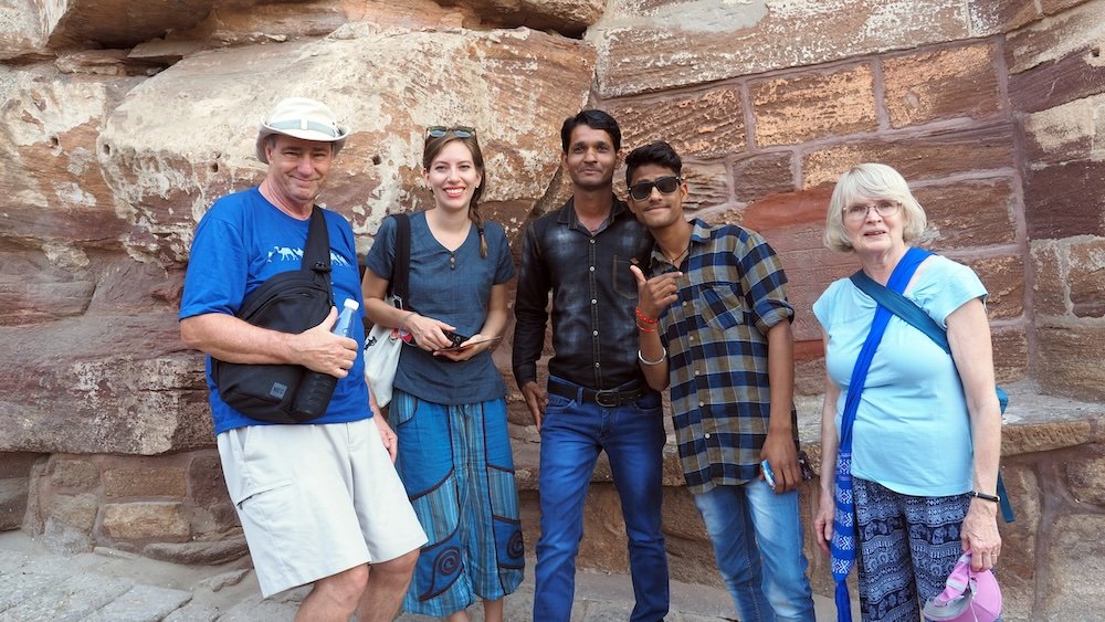 Nomadic Samuel family group posing with tourists in Jodhpur, Rajasthan, India 