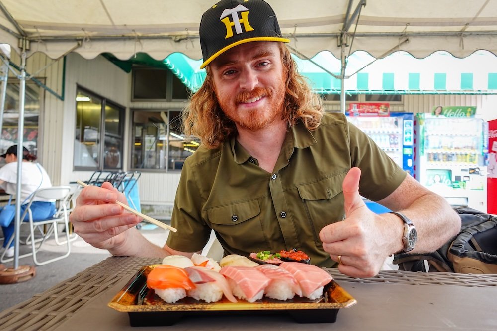 Nomadic Samuel feasting on delicious seafood and sushi at Pier Bandai in Niigata, Japan 