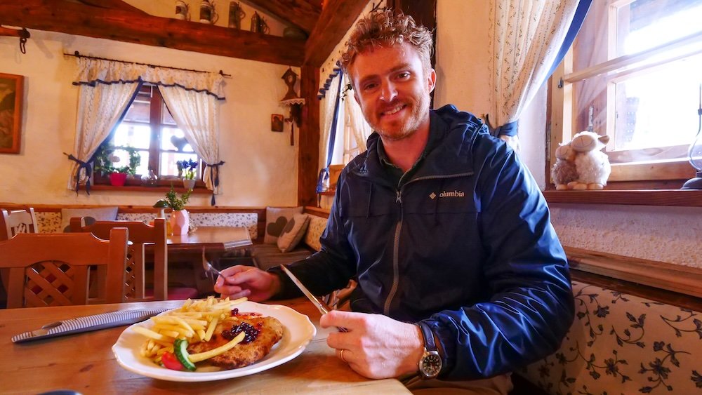 Nomadic Samuel feasting on hearty German cuisine in the German Alps