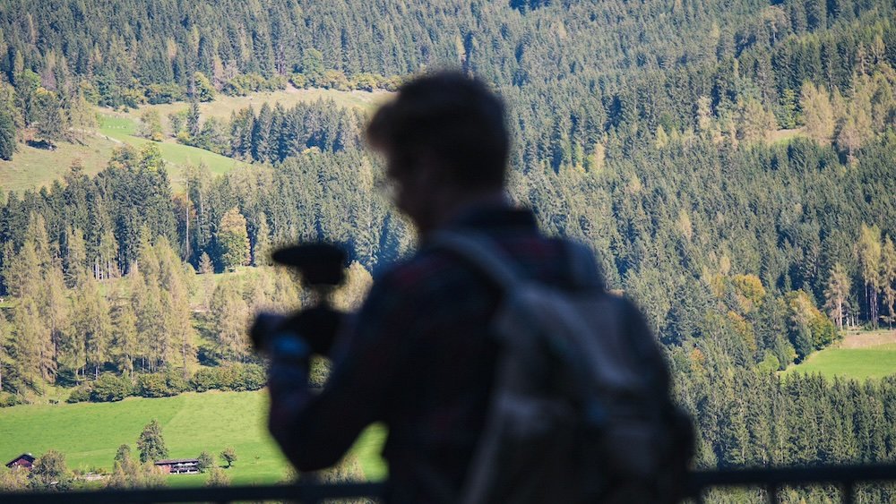 Nomadic Samuel filming and taking photos in Werfen, Austria 