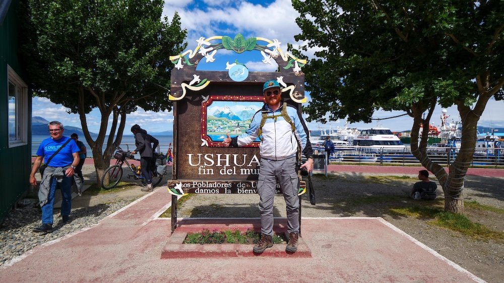 Nomadic Samuel giving a thumbs up to Ushuaia at the end of the world in Argentina 