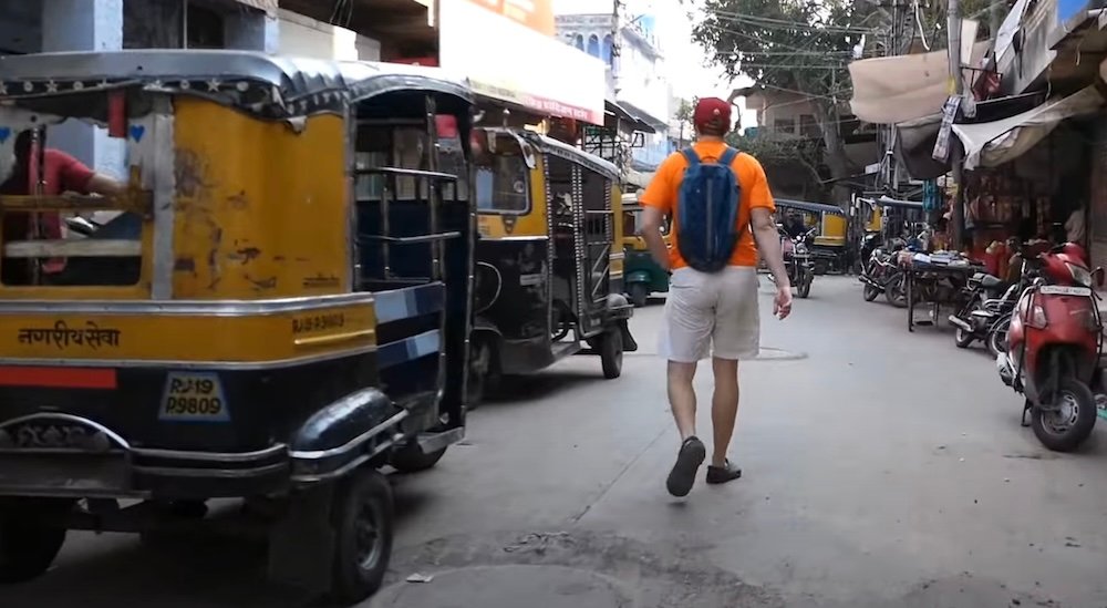 Nomadic Samuel hailing an auto-rickshaw for a ride in Jodhpur, India 