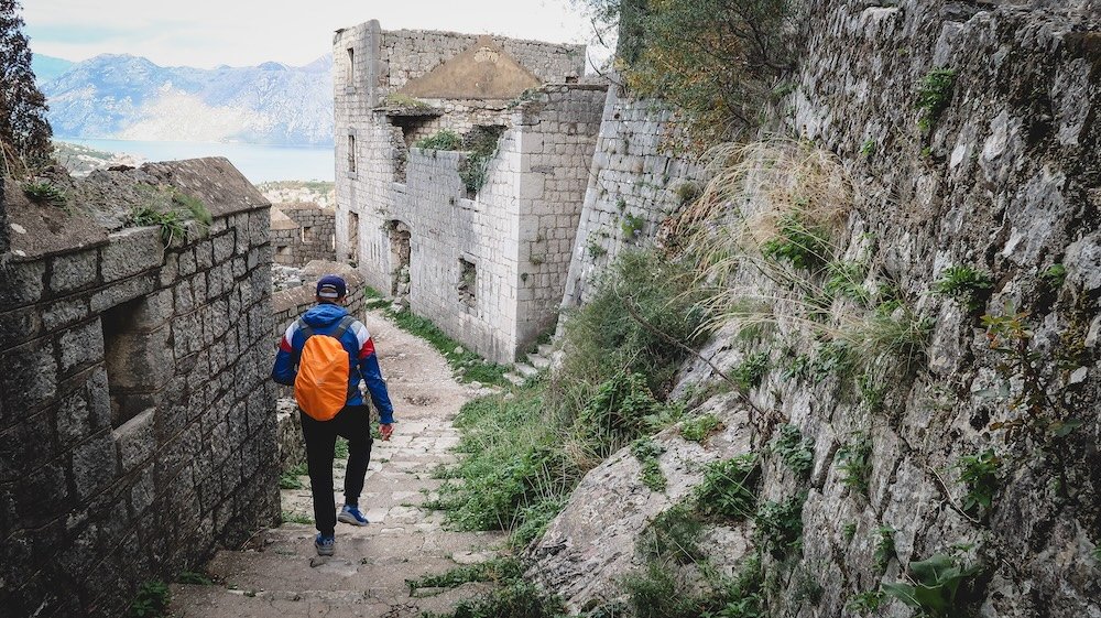 Nomadic Samuel hiking in Kotor, Montenegro as a day trip option from Budva 