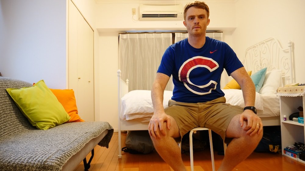 Nomadic Samuel posing inside the Osaka hotel room 