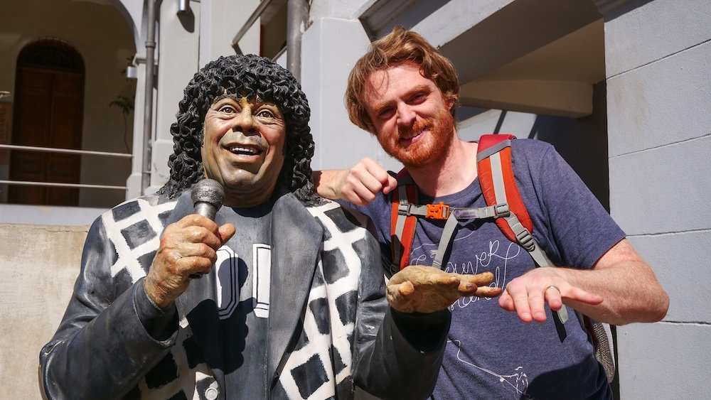 Nomadic Samuel posing with a tango singer in Cordoba City, Argentina 