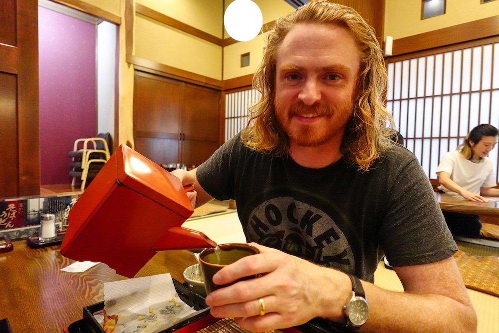 Nomadic Samuel enjoying noodle broth in Yuzawa, Niigata prefecture, Japan 