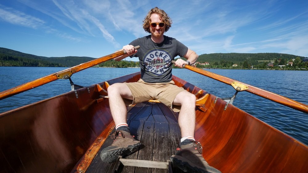 Nomadic Samuel rowing a boat in the Black Forest in Germany 