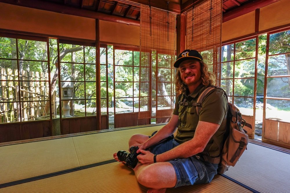 Nomadic Samuel sitting down to enjoy the rich cultural heritage at Northern Culture Museum Niigata Complex