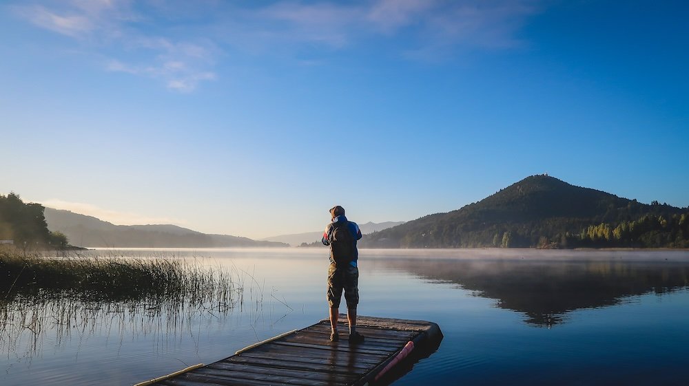 Nomadic Samuel taking lakeside photos in Bariloche, Argentina early in the morning 