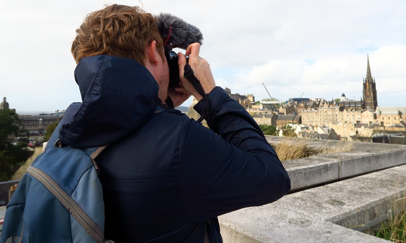 Nomadic Samuel taking some photos and video from a high vantage point in Edinburgh, Scotland