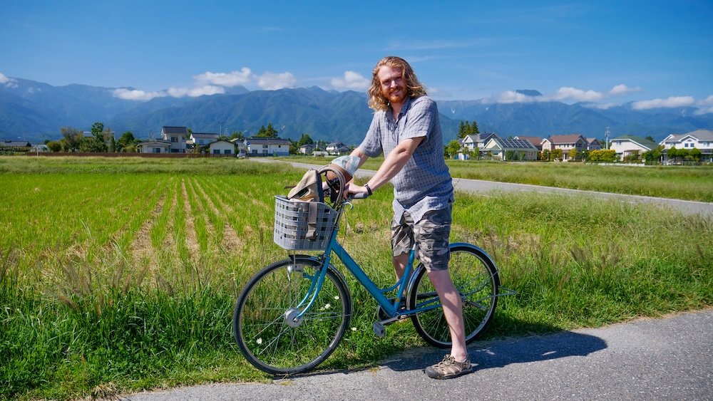 Nomadic Samuel visiting Daio Wasabi Farm renting and riding a bicycle in Japan on Rural Japan Day Trip from Matsumoto