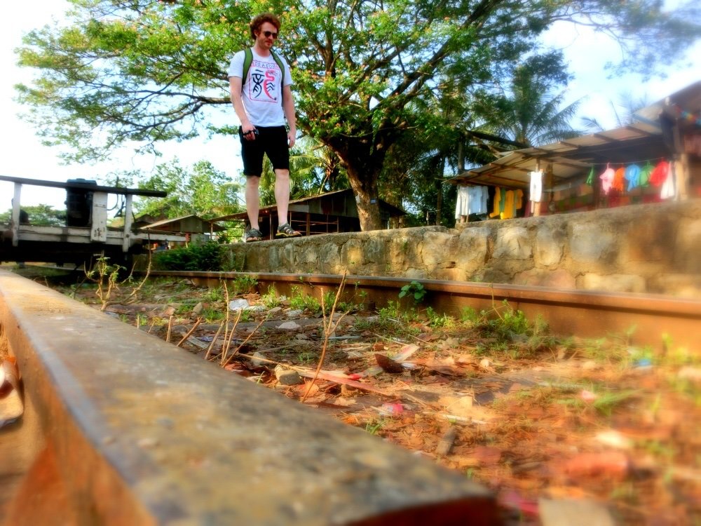 Nomadic Samuel walking by the bamboo train tracks in Battambang, Cambodia 