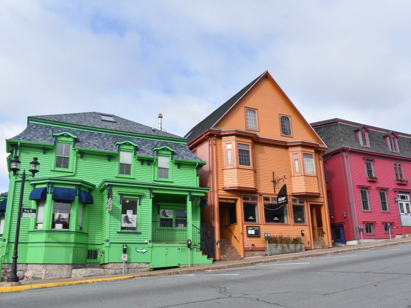 Nova Scotia traditional colourful houses in Canada featuring red, orange and green 