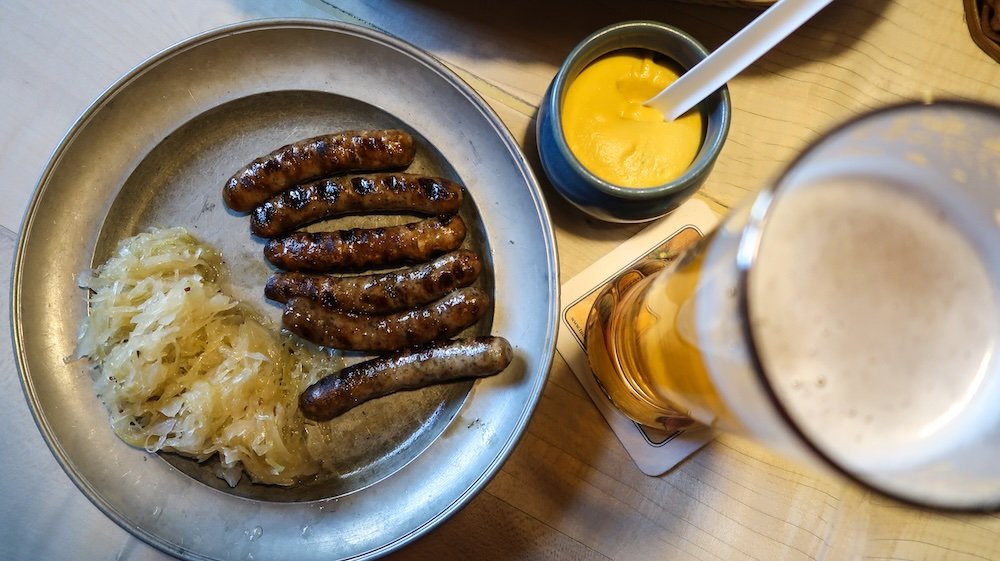 Nürnberger Rostbratwurst Eating Nuremberg Sausage at Bratwursthäusle finger-sized and spiced with marjoram in Nuremberg, Germany