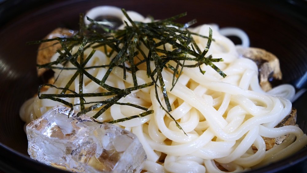 Udon noodles cooled by ice in Shirakawago, Japan 