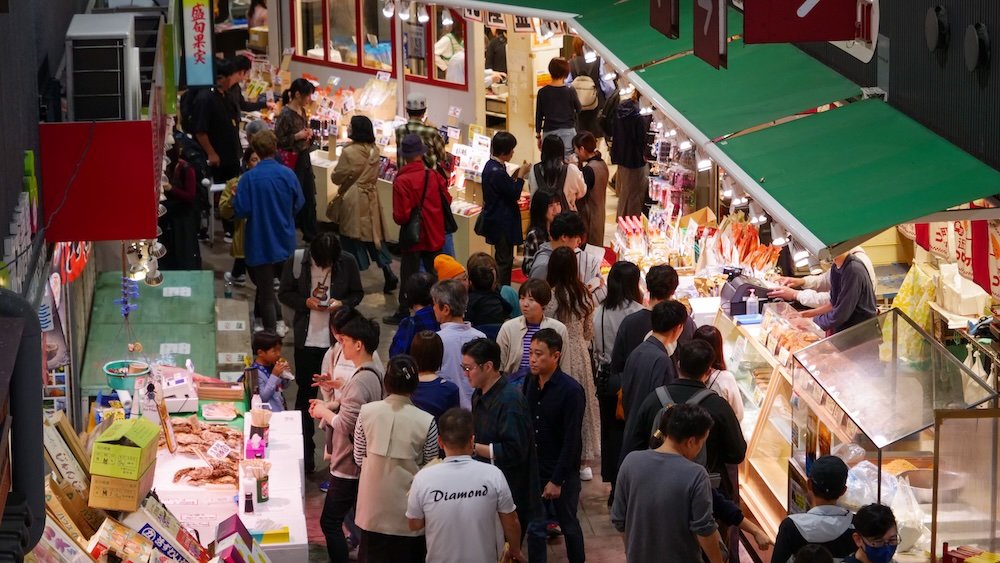 Omicho Market overhead views with pedestrians shopping and eating in Kanazawa, Japan 