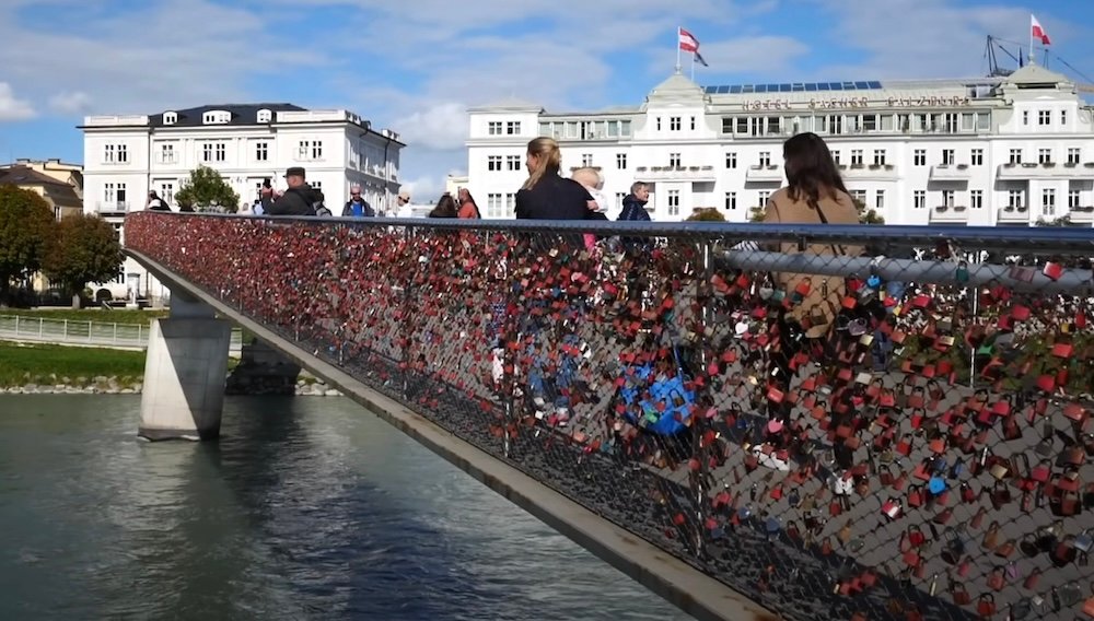 Pedestrian walking bridge with love locks crossing the Salzach River in Salzburg, Austria