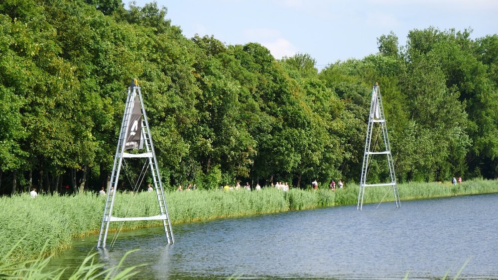 Pedestrians, walkers and bicycling off in the distance from Lake Malta Maltanski Reservoir in Poznan, Poland