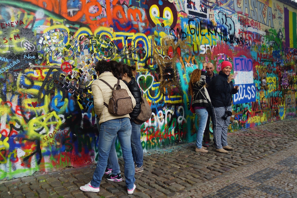 People hanging out by the John Lennon Wall in Prague, Czech Republic