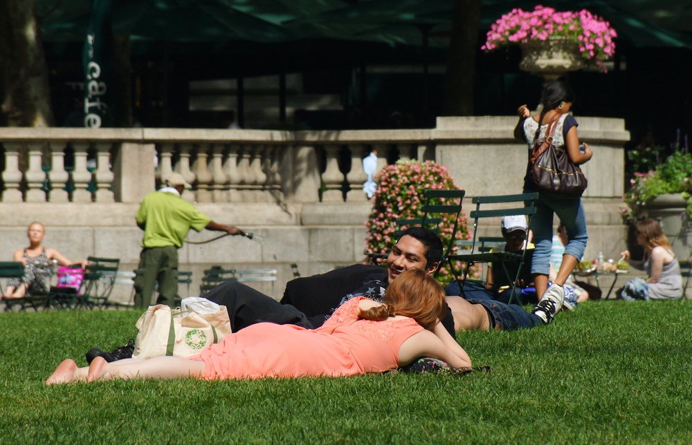 People lying on the grass at Bryant Park in New York City