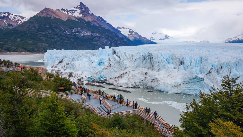 Perito Moreno Glacier Viewed from the Boardwalks in Santa Cruz, Patagonia Visitors observe the immense blue ice wall of Perito Moreno Glacier from the boardwalks in Los Glaciares National Park, Santa Cruz, Argentine Patagonia.