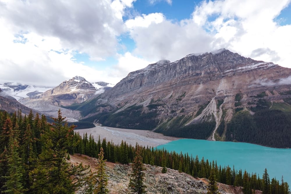 Peyto Lake glacial valley and outwash plain, Icefields Parkway, Banff National Park, Alberta A wide view from the Peyto Lake viewpoint in Banff National Park, Alberta, showing a glacier-carved valley and pale sediment delta feeding into the lake's turquoise water along the Icefields Parkway.