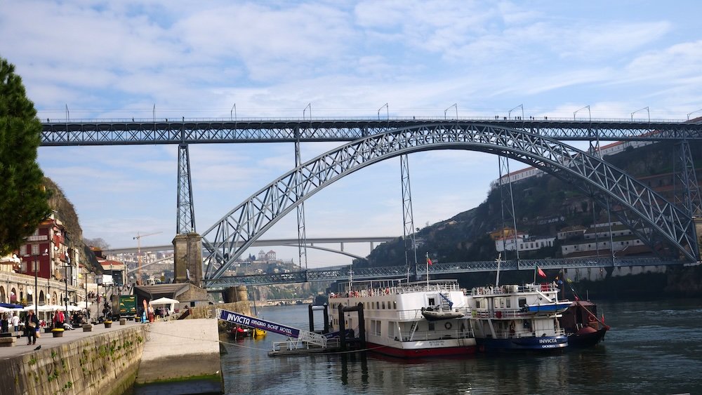 Porto bridge and ferries from a ground level perspective in Portugal 